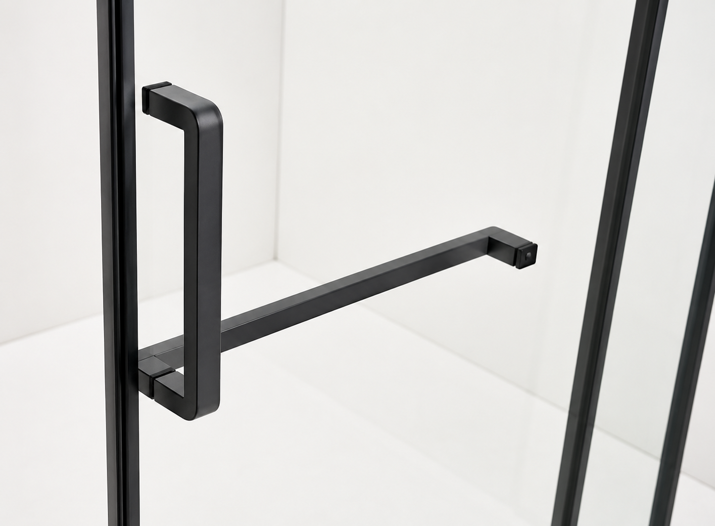 Black metal handle on a glass door with a white background