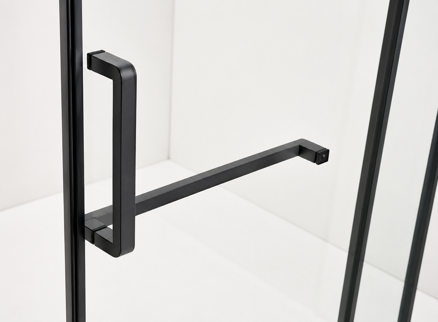 Black metal handle on a glass door with a white background