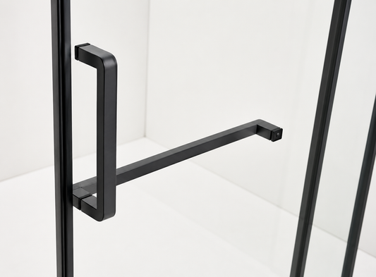 Black metal handle on a glass door with a white background