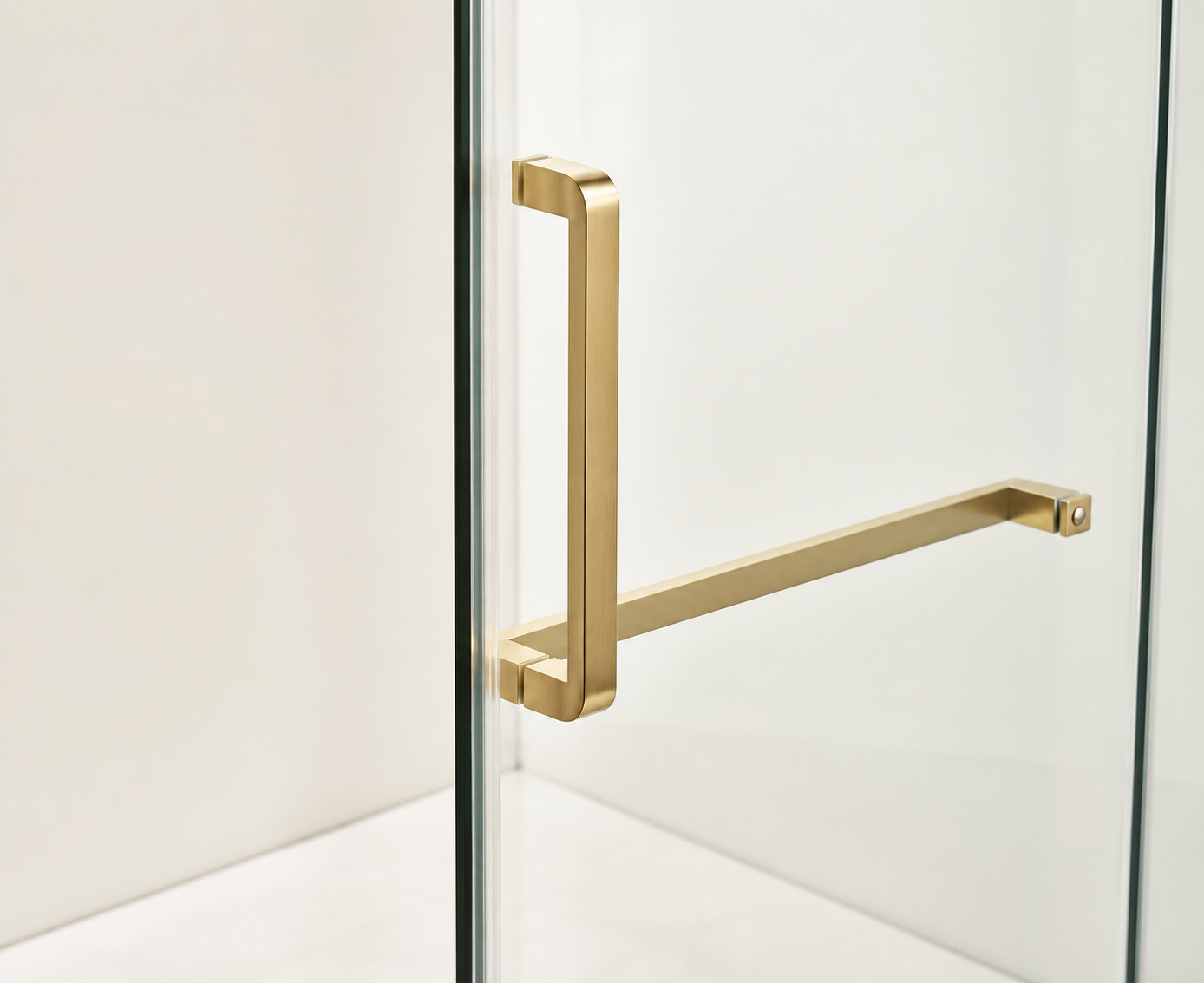 Gold towel bar mounted on a glass wall with a white background