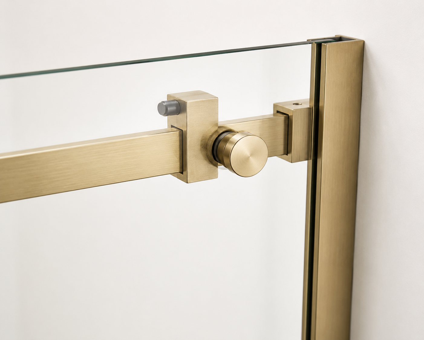Close-up of a gold-framed glass door handle on a white background