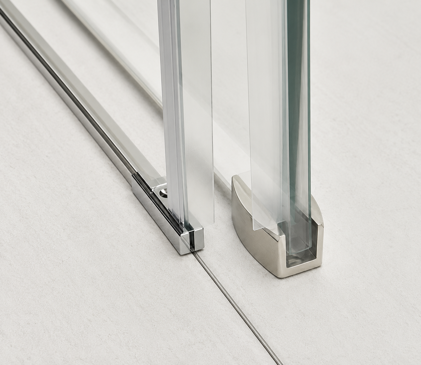 Close-up of a glass shower door with chrome fixtures on a white background