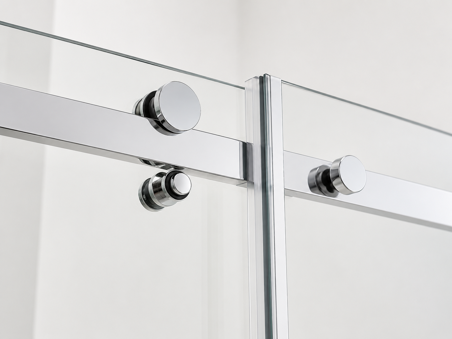 Glass shower enclosure with chrome fixtures on a white background